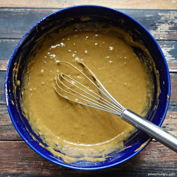 blue bowl filled with batter for vegan grain-free gingerbread muffins