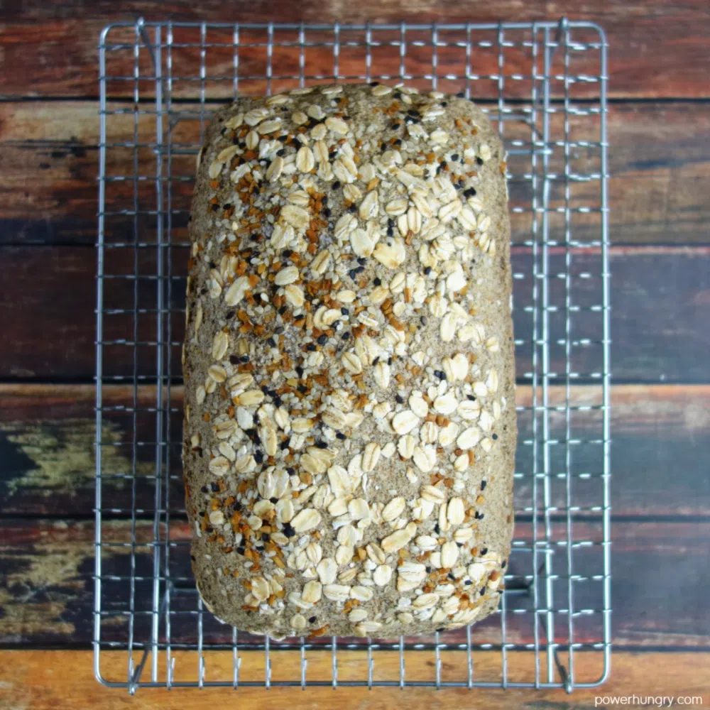 a loaf of vegan gluten-free bread on a wire cooling rack