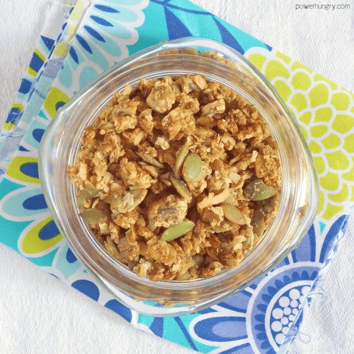 grain-free granola in a glass jar atop a blue and yellow napkin