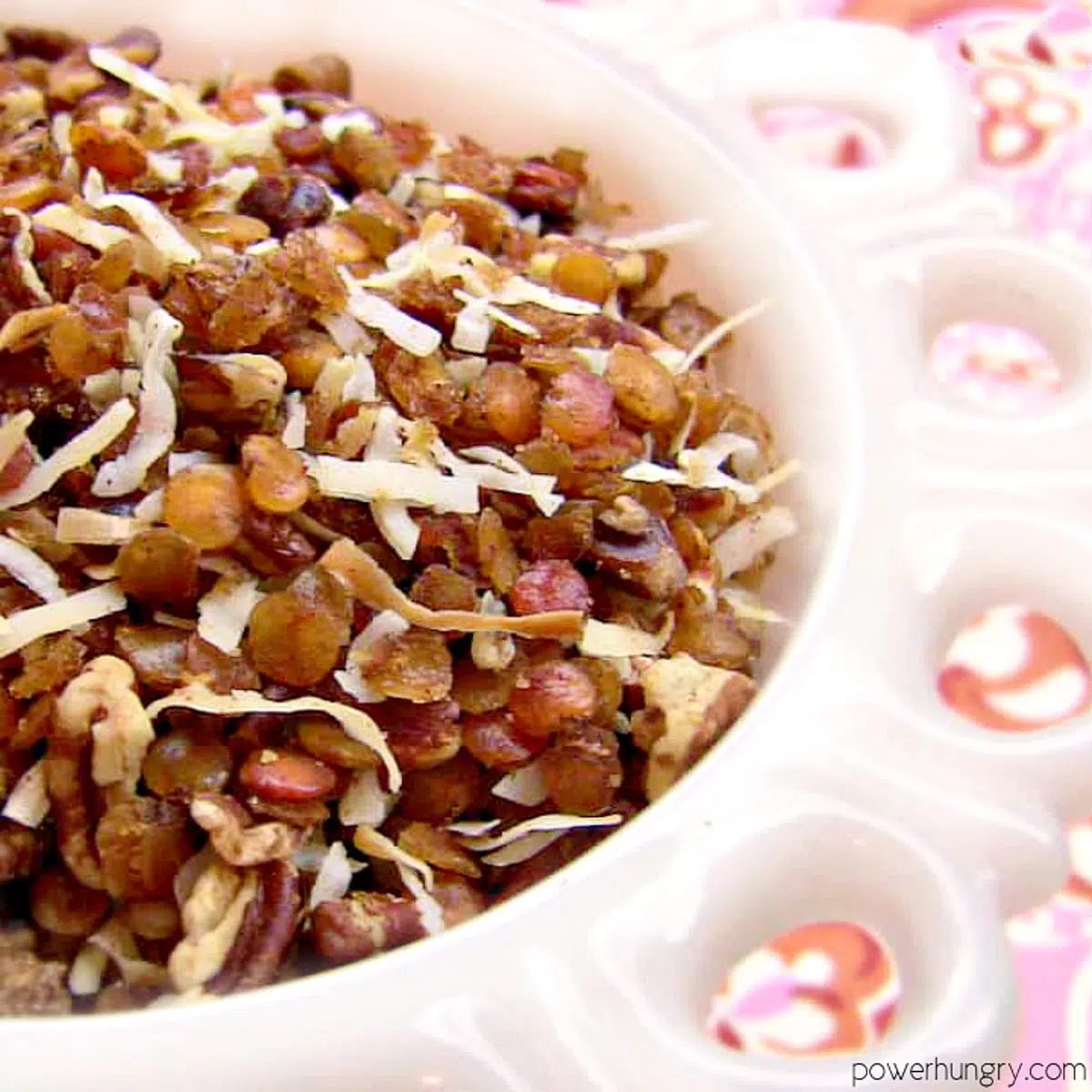 bowl of red lentil granola on a pink and orange napkin