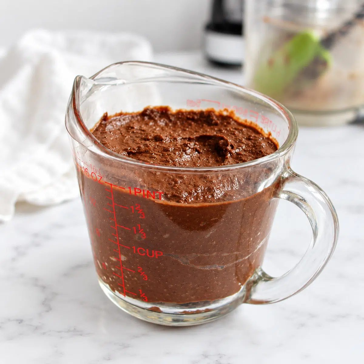 2 cups of brownie batter hummus in a measuring cup