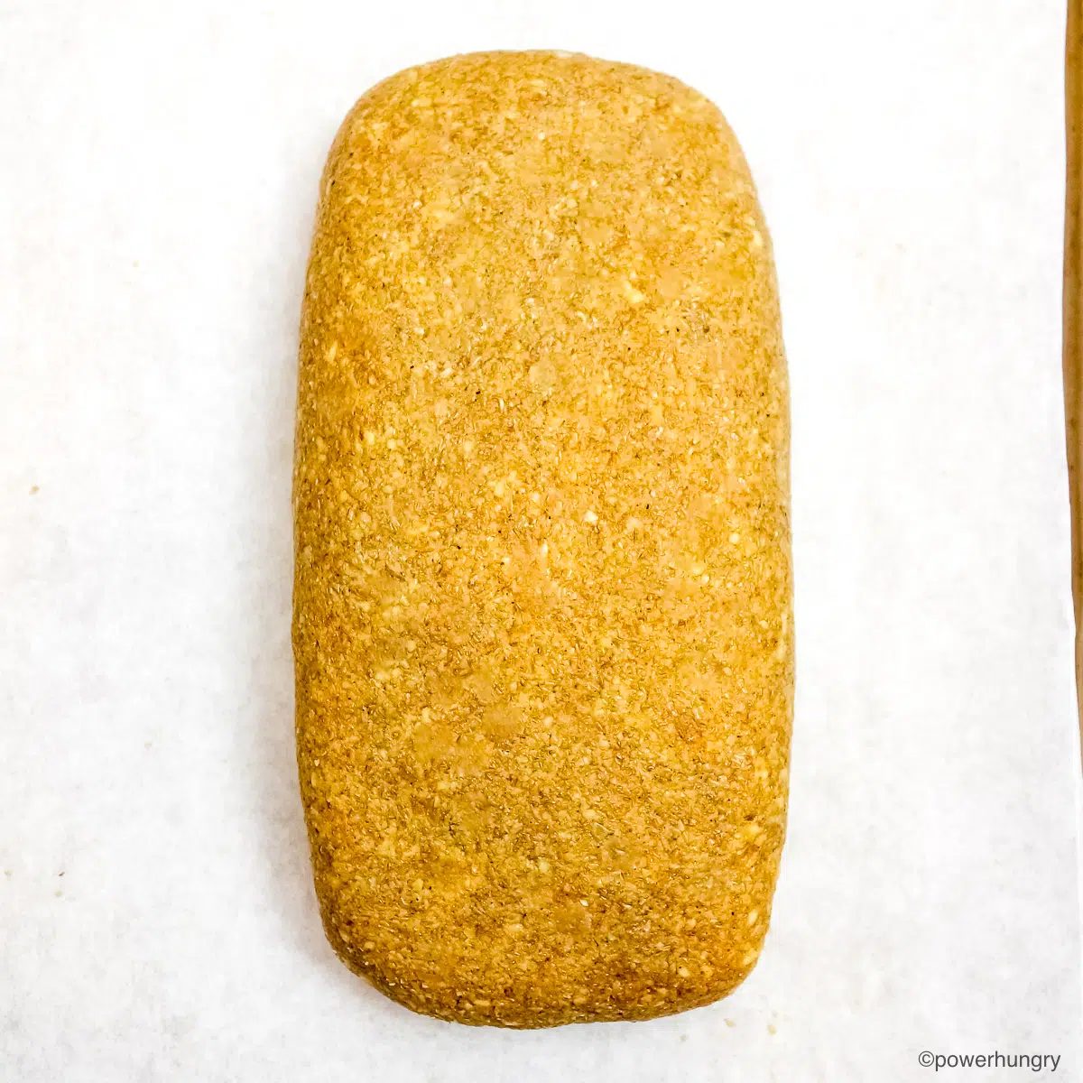 shaped banana lentil bread dough on a parchment paper lined baking sheet