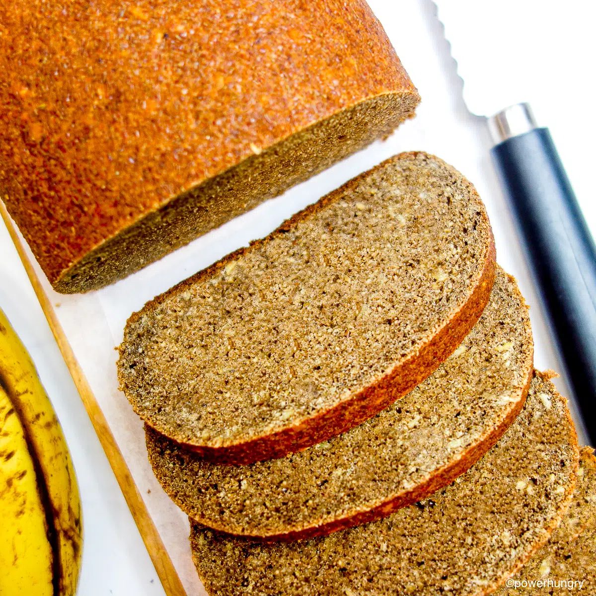 overhead shot of banana lentil bread, sliced, on a cutting board