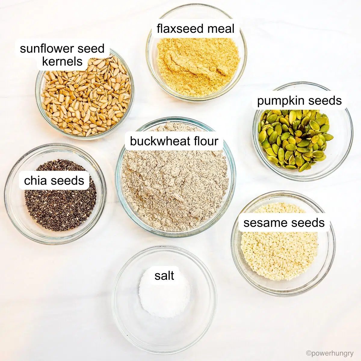 ingredients, in glass bowls, for seeded buckwheat crackers