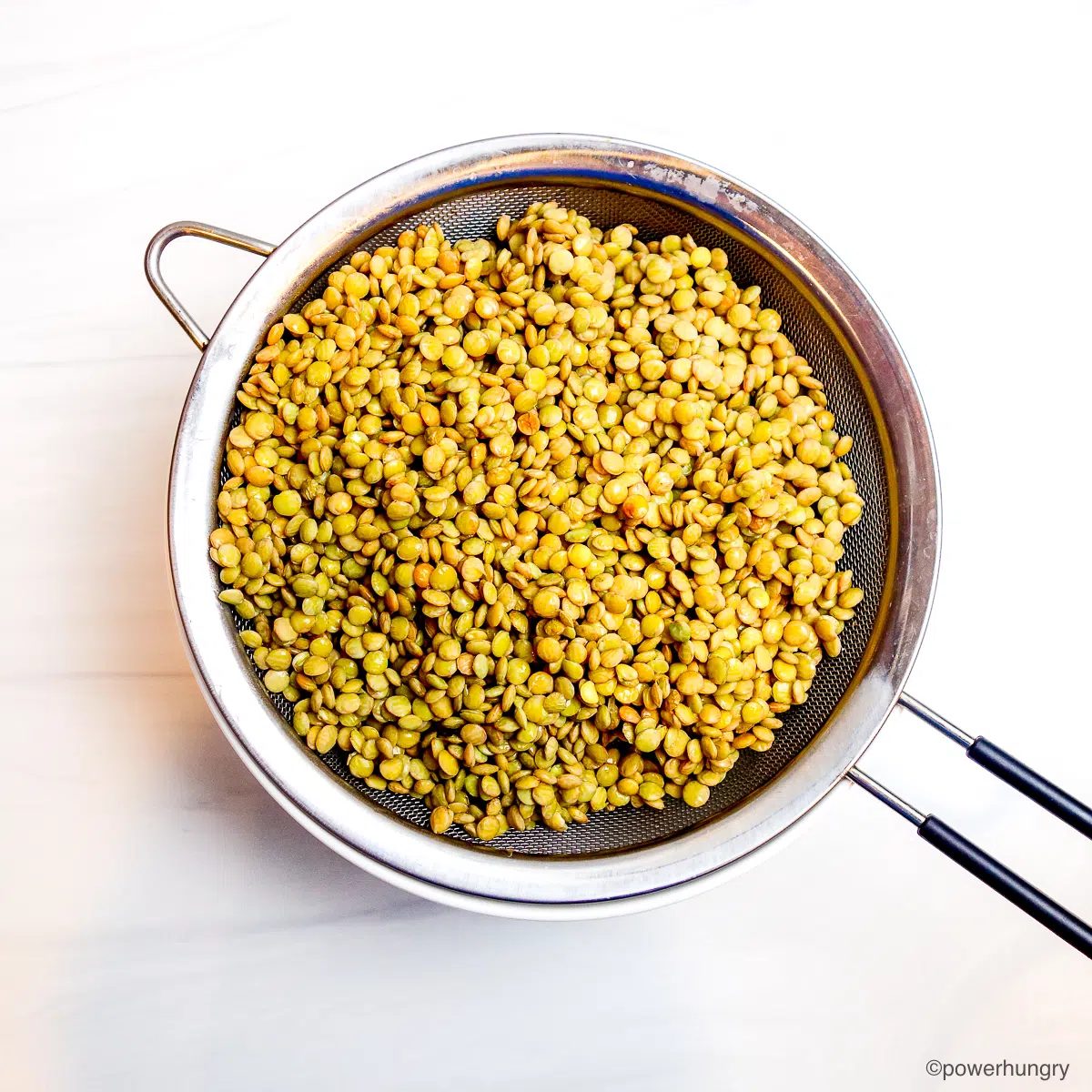 gained soaked lentils in a mesh sieve