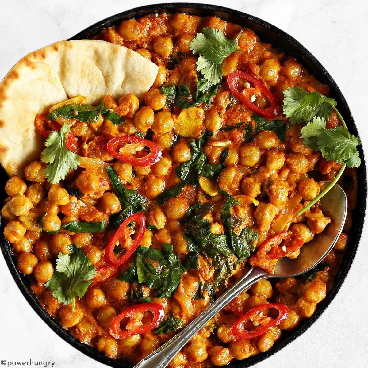 high protein chickpea curry with a piece of naan