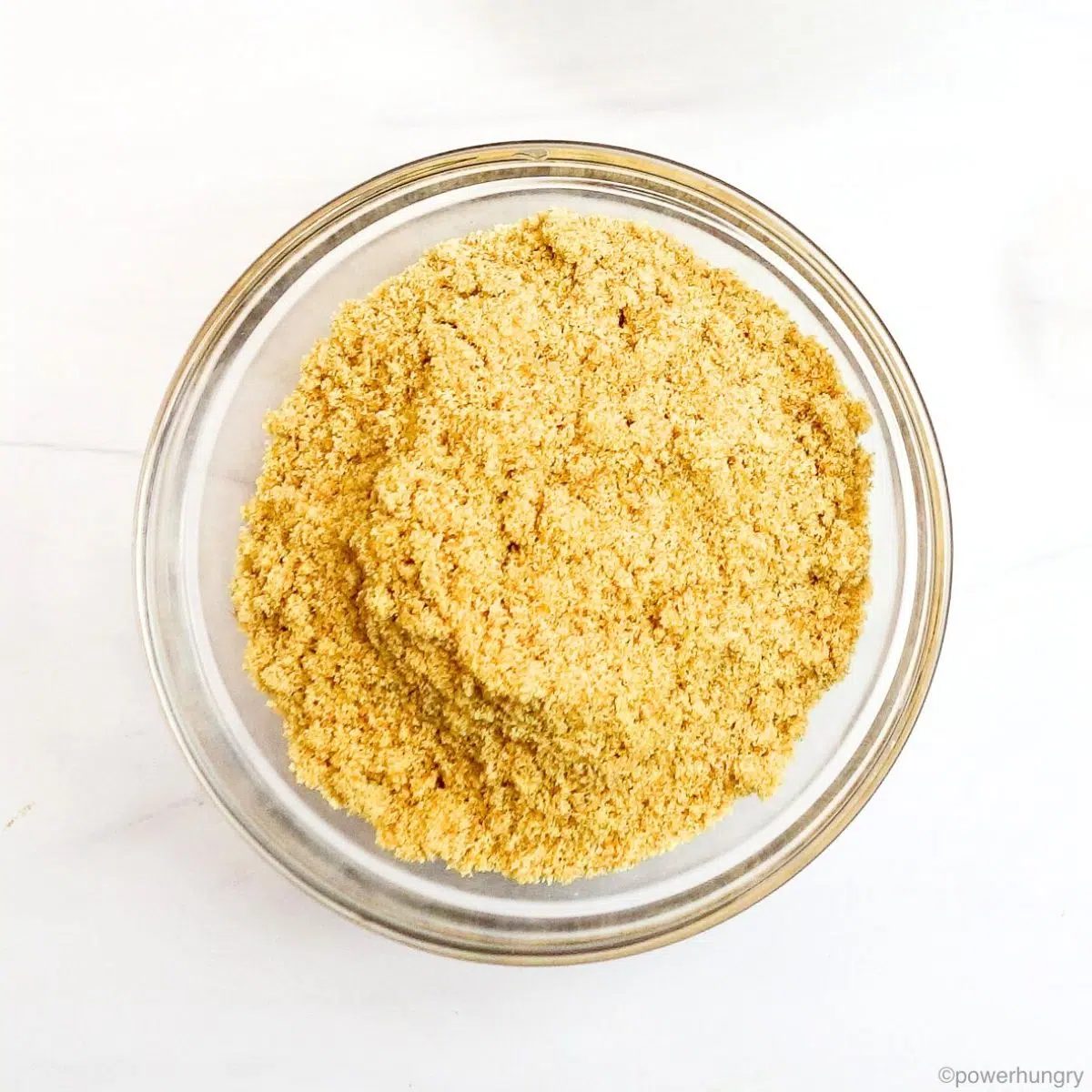 glass bowl filled with golden flaxseed meal