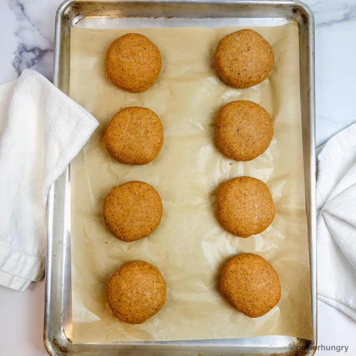 baked red lentil bread rolls on a baking sheet