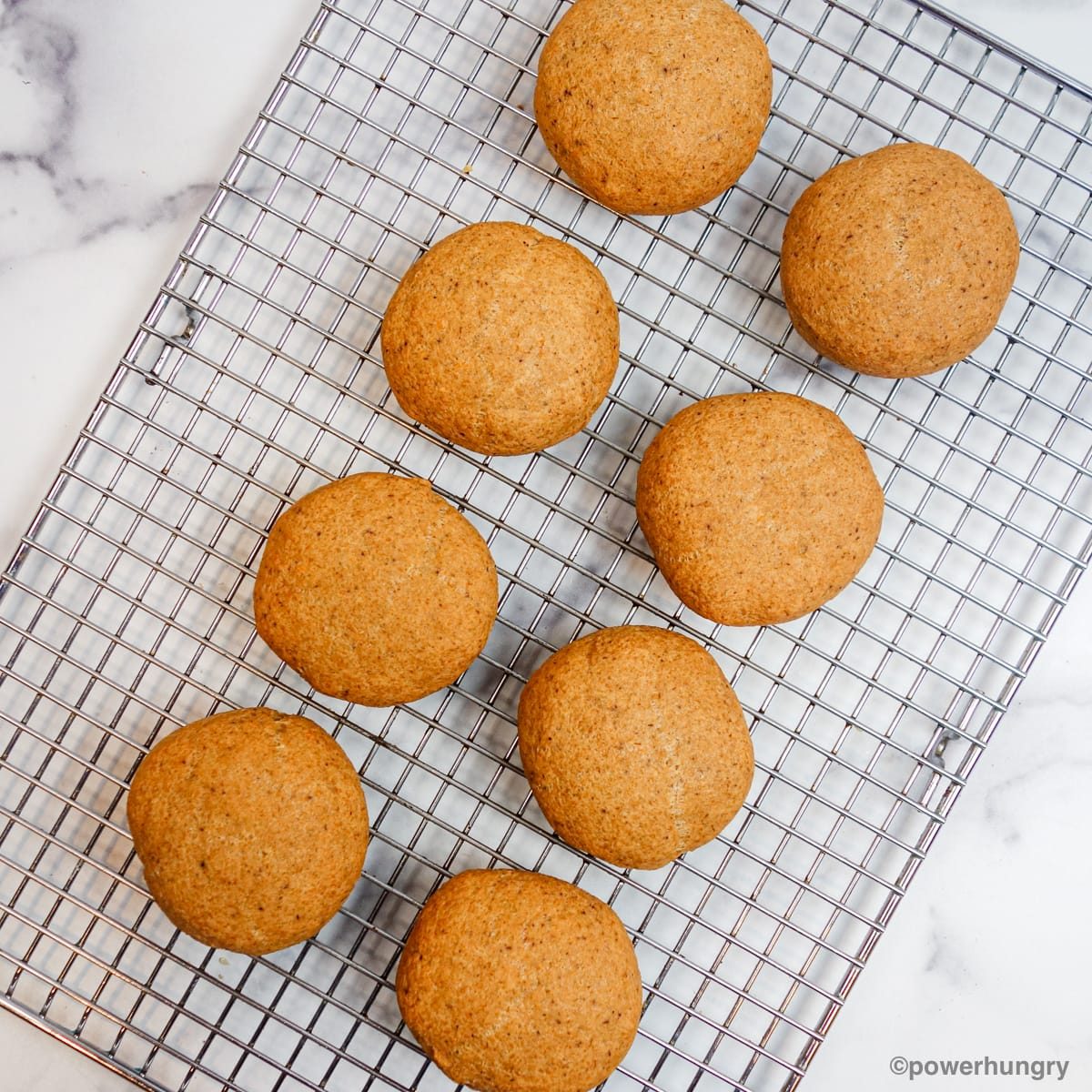 cooled lentil bread rolls on a silver cooling rack