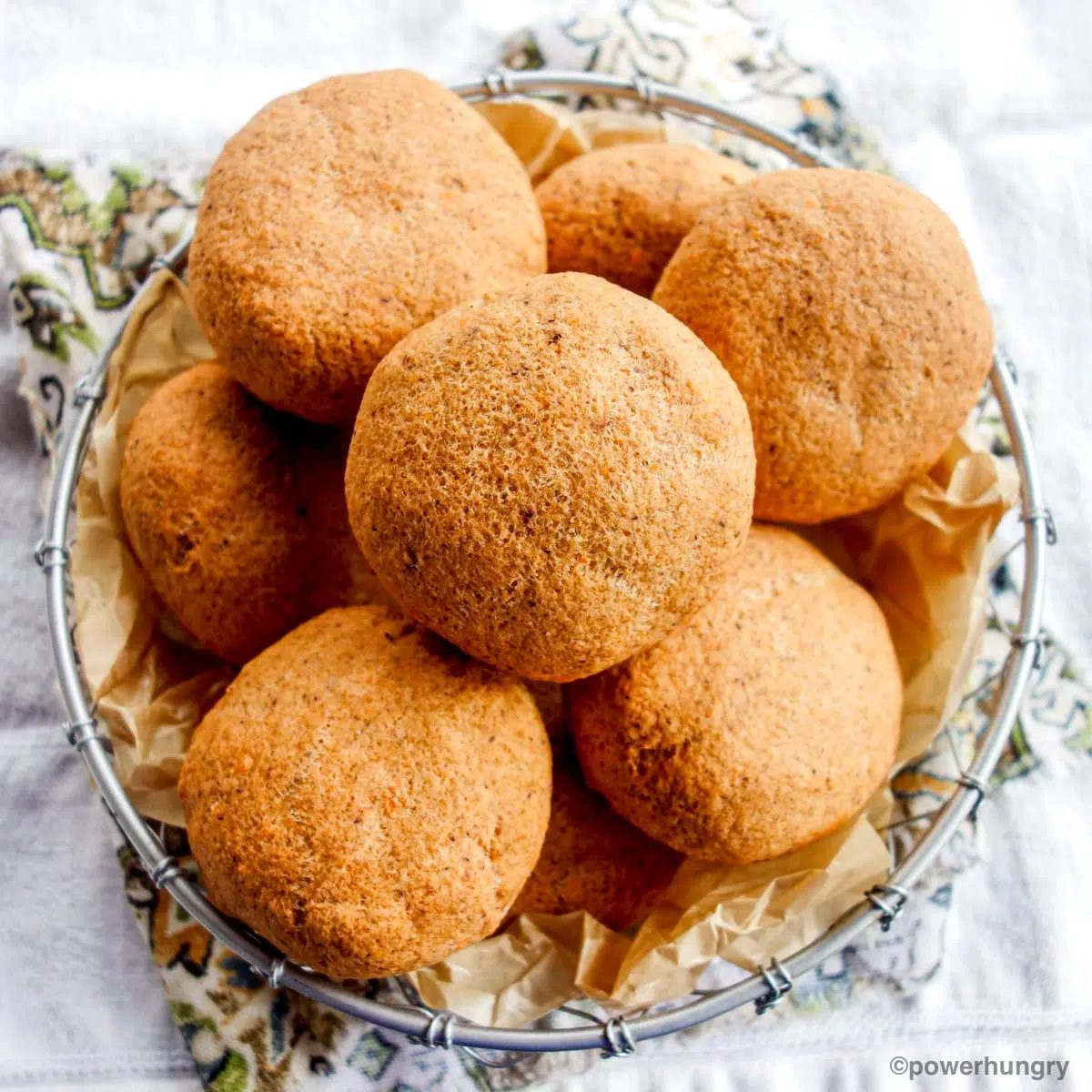 overhead shot of a wire basked filled with lentil bread rolls