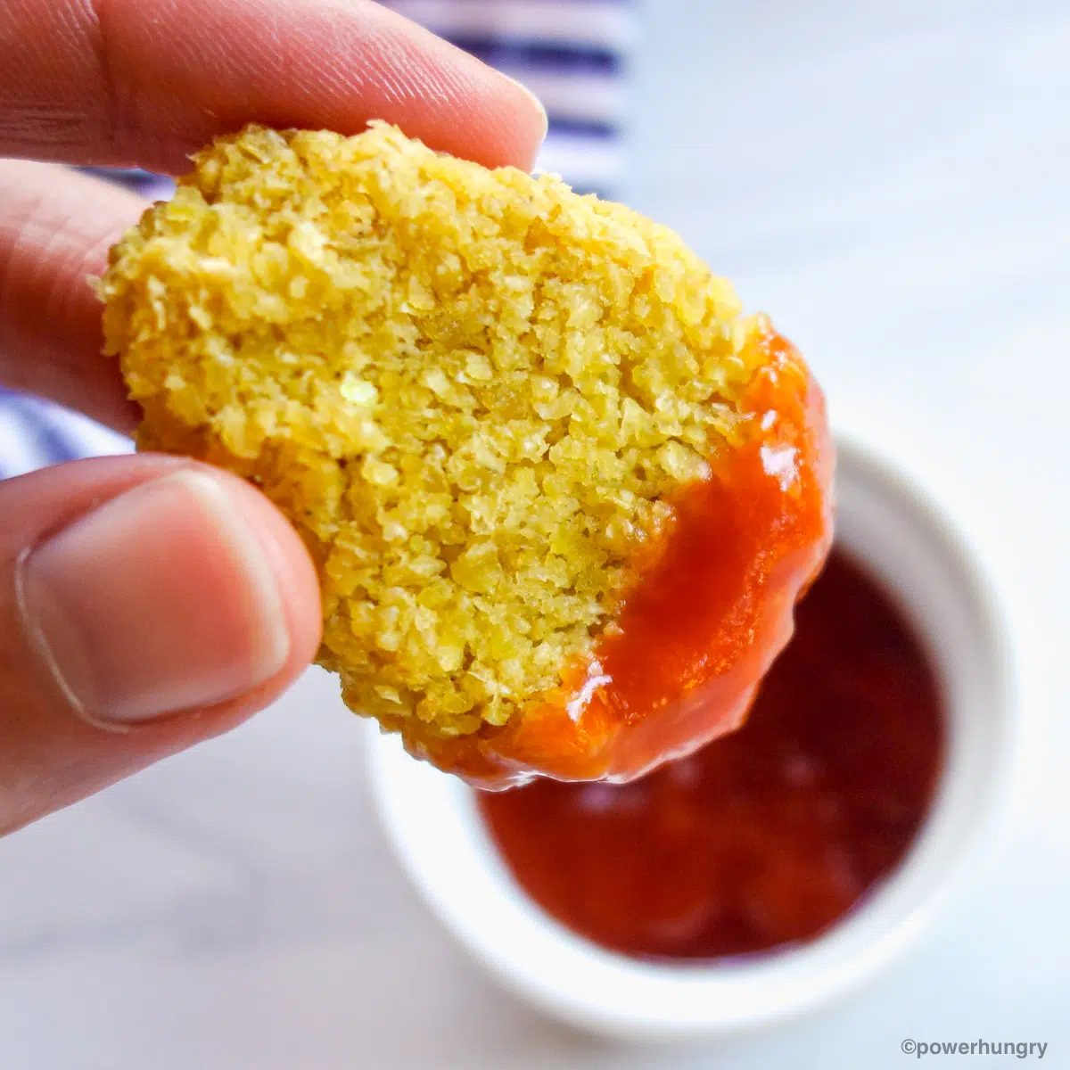 millet nugget dipped into ketchup