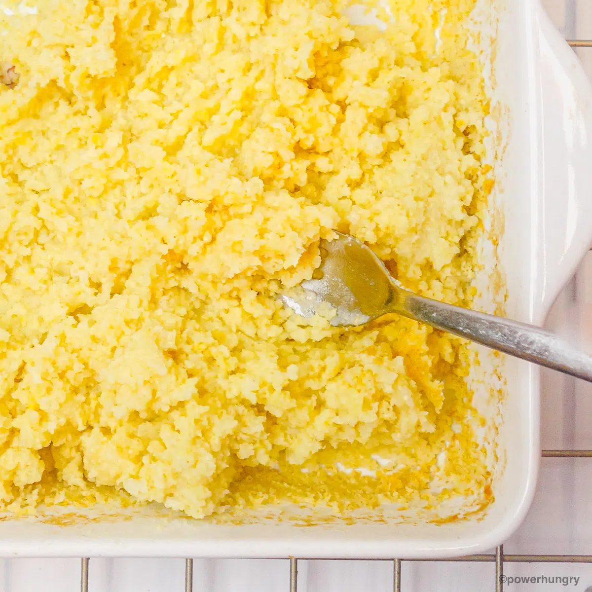 close up of cooked millet getting fluffed with a fork