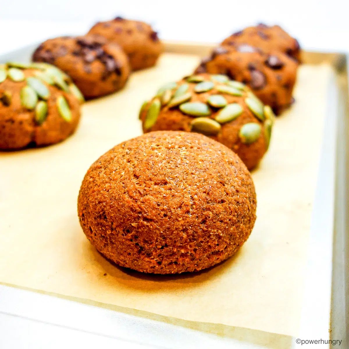 close up of pumpkin lentil rolls on a baking sheet