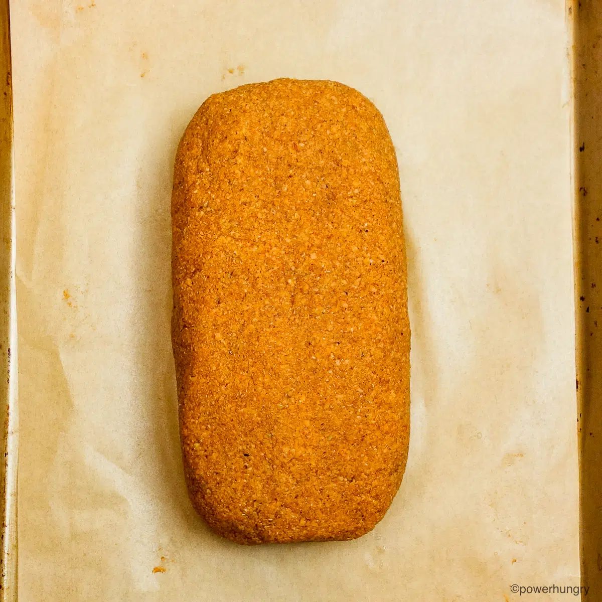 loaf of unbaked lentil pumpkin bread on a baking sheet