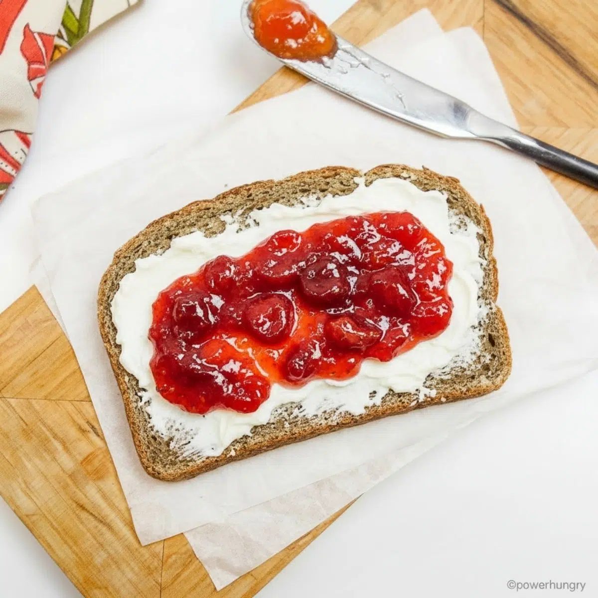 nourishing bread slice with vegan cream cheese and strawberry jam
