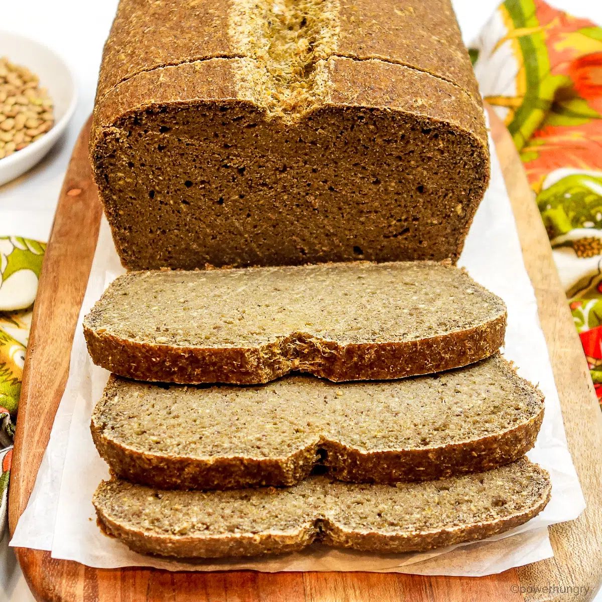 close up of lentil tofu protein bread on a cutting board, sliced