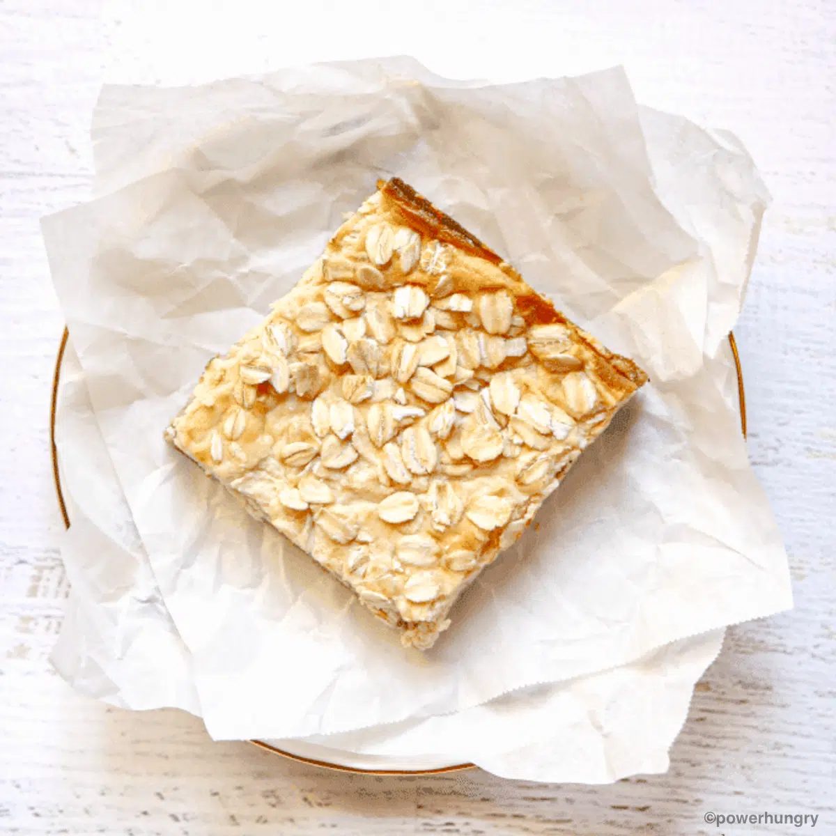 high protein vegan cheesecake bar on a white piece of parchment paper