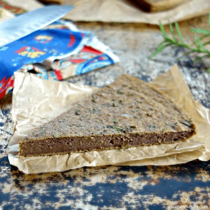 wedge of lentil flatbread on a piece of parchment paper