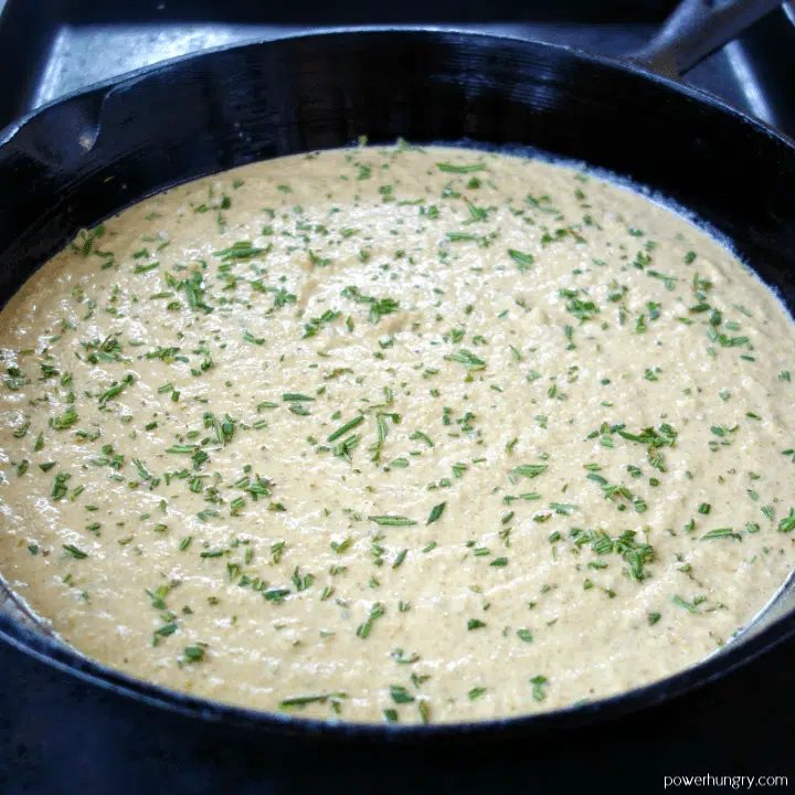 raw lentil batter in a cast iron skillet