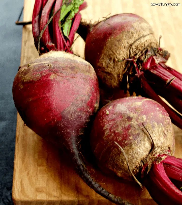 3 medium-large raw beets on a cutting board