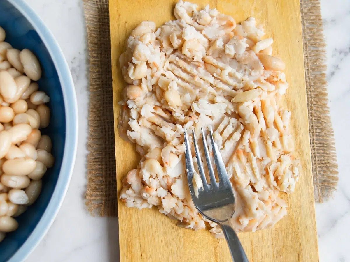 mashed white beans on a cutting board