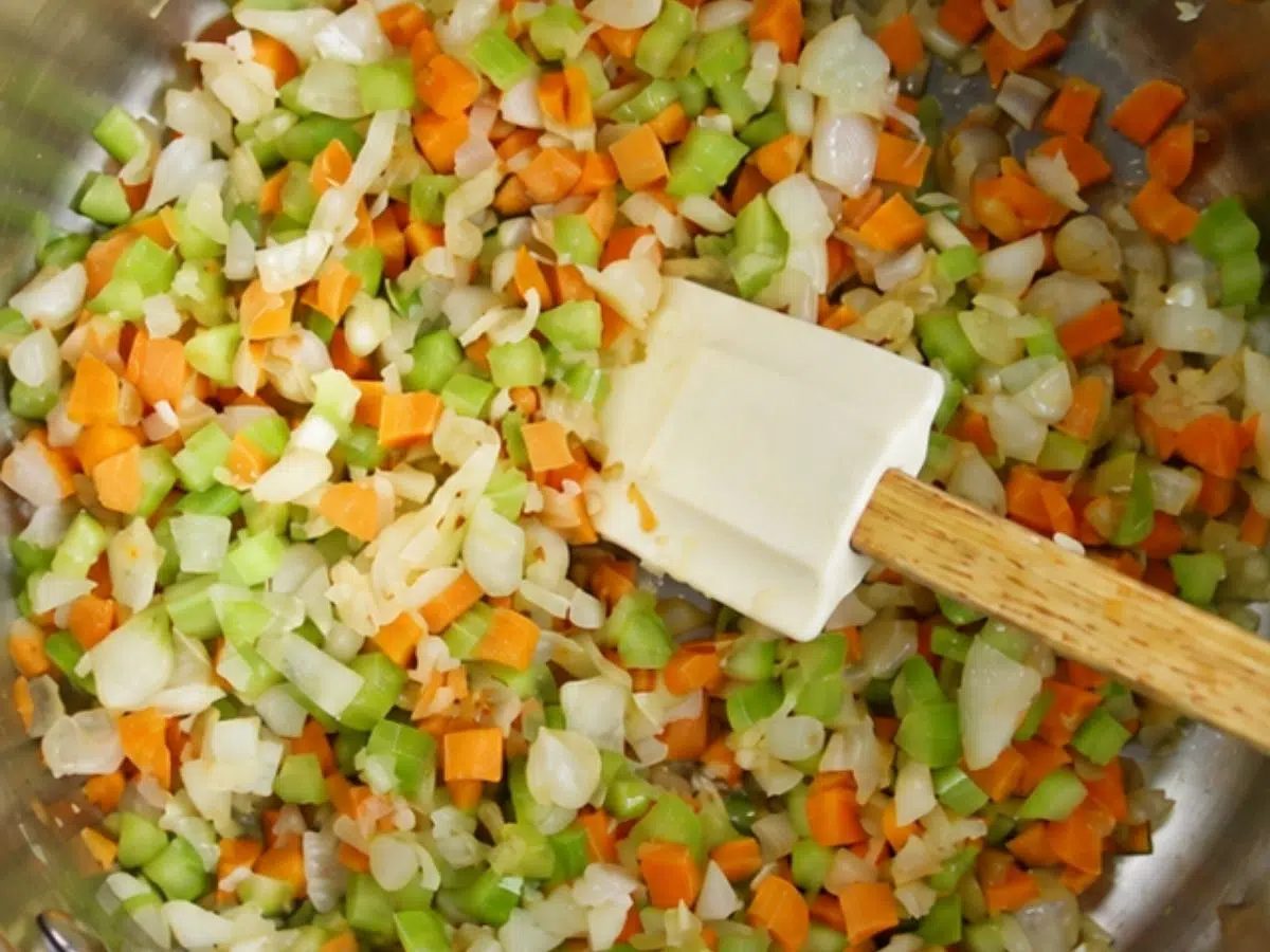 pot filled with vegetables getting softened for soup