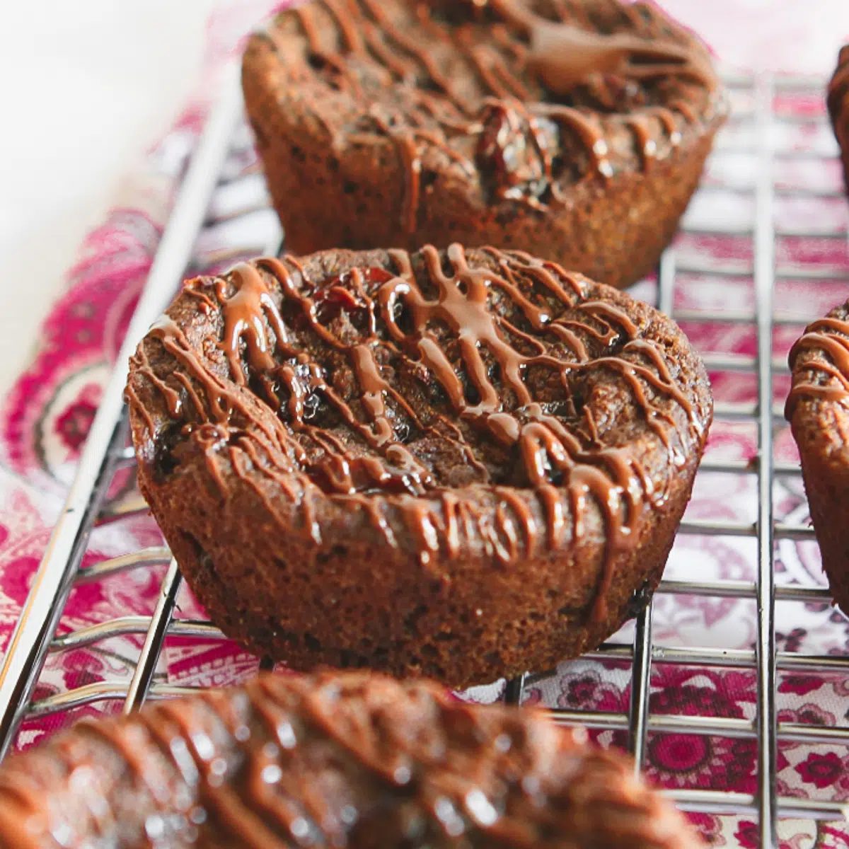 there jumbo chocolate raisin cookies on a cooling rack