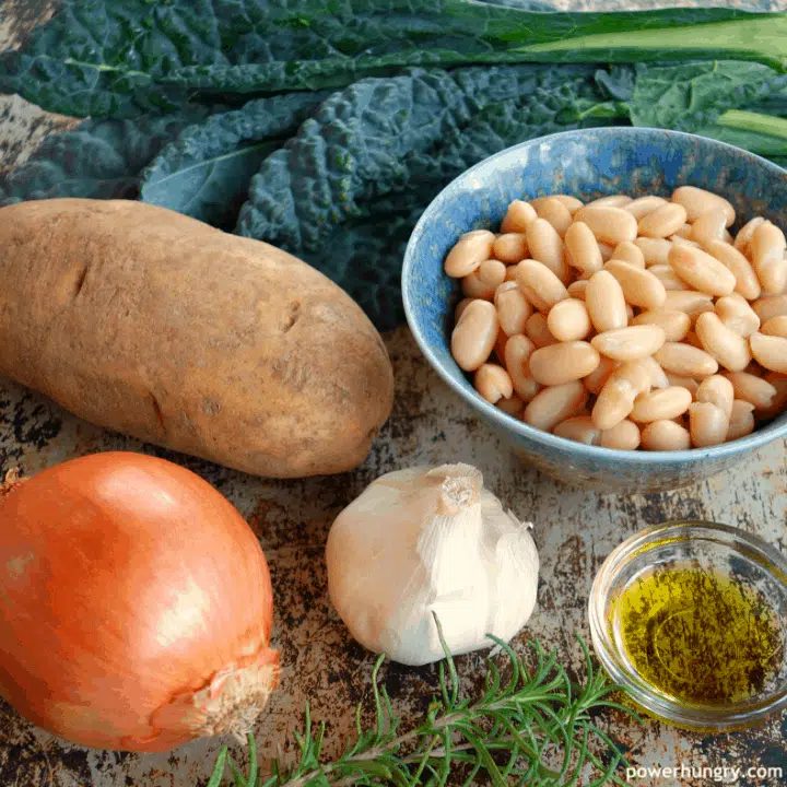 Ingredients for Kale Potato & White Bean Soup on a baking sheet