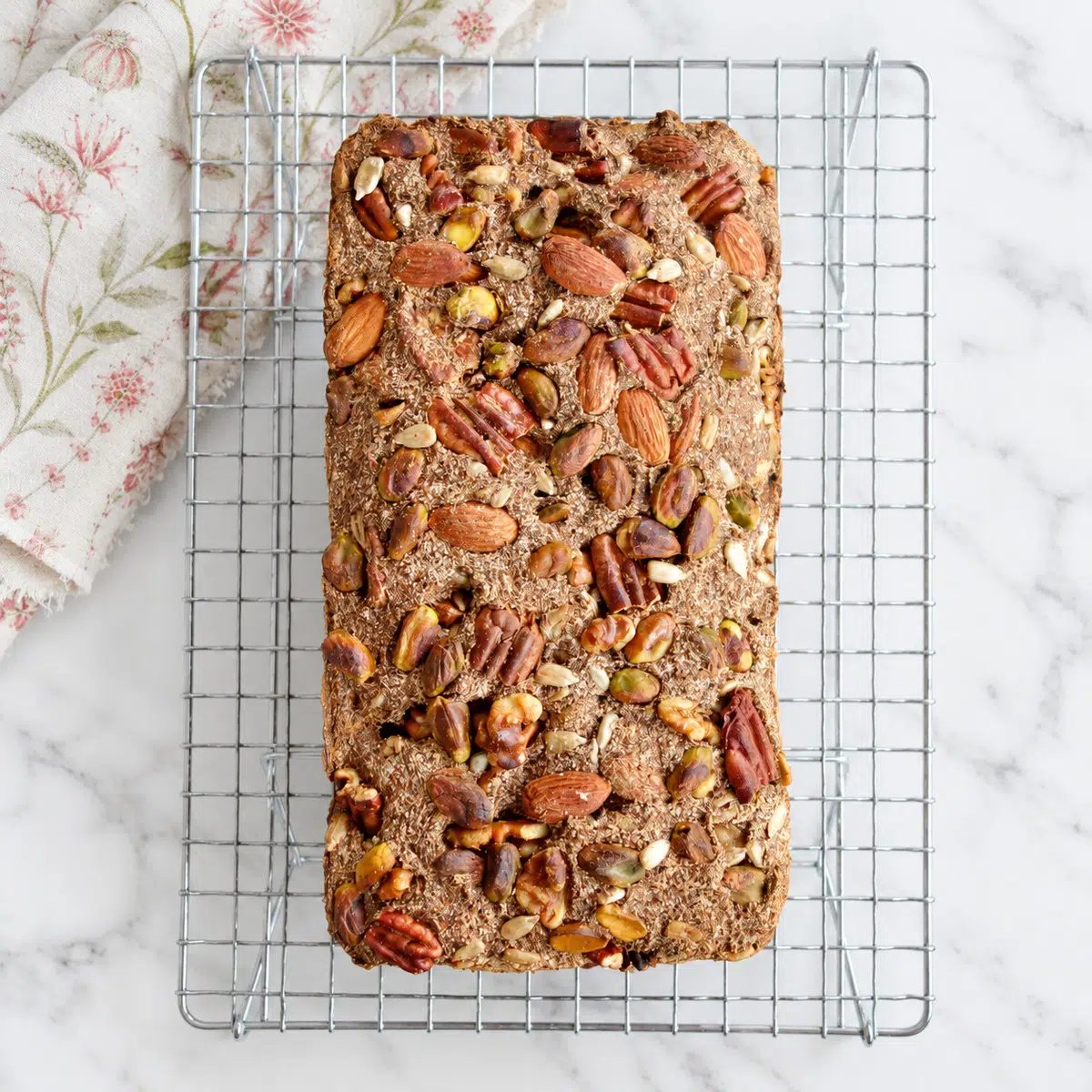 baked vegan coconut flour bread on a cooling rack, overhead