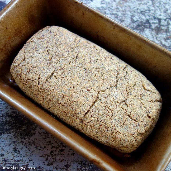 baked coconut flour bread in a gold metal loaf pan