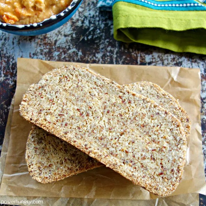two stacked slices of egg-free coconut flour bread on brown parchment paper