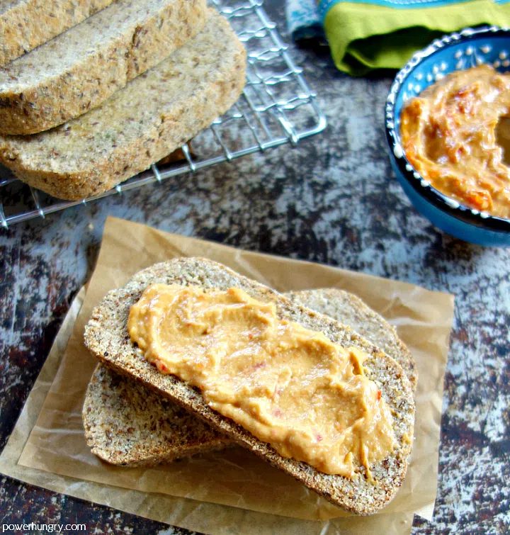 overhead shot of slices of coconut flour bread spread with hummus
