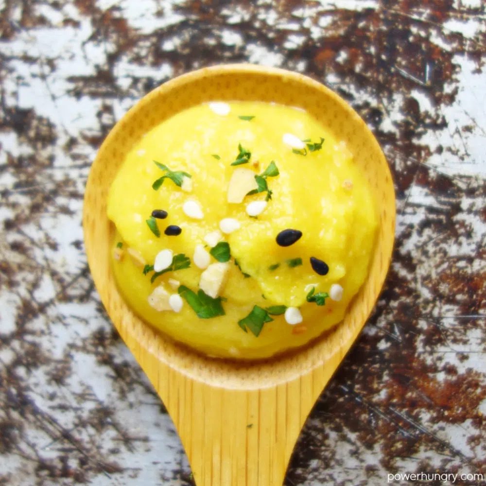 a wooden spoon filled with yellow split pea dip