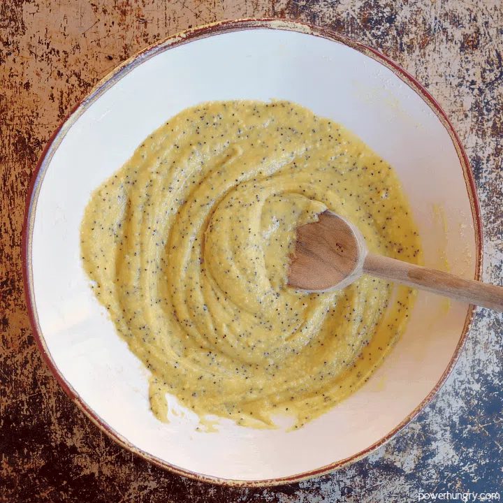 white bowl full of lemon poppy seed muffin batter