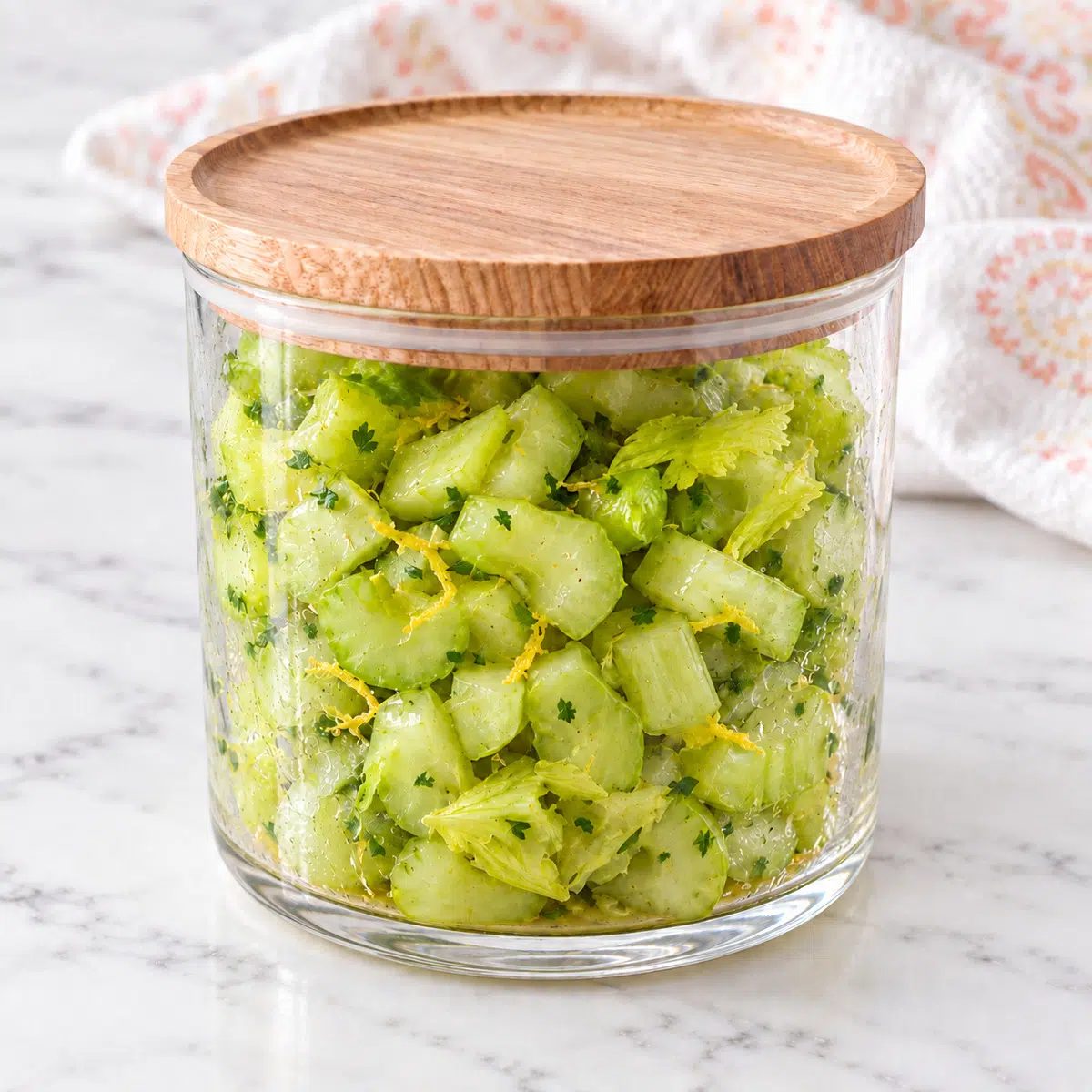 lemony celery salad in a wood-topped glass jar