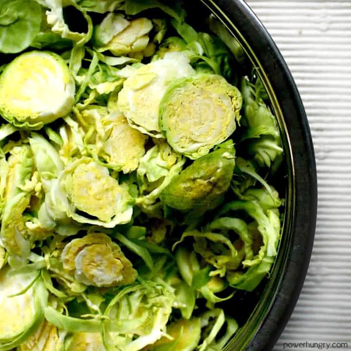 shredded brussels sprouts in a bowl atop a white linen napkin