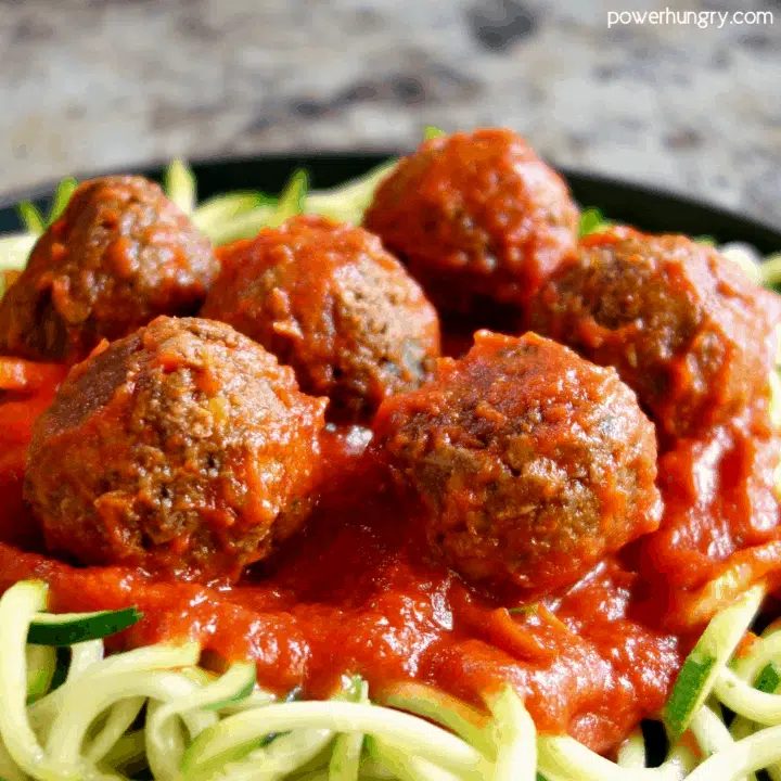 close up shot of marinara-covered lentil and mushroom meatballs