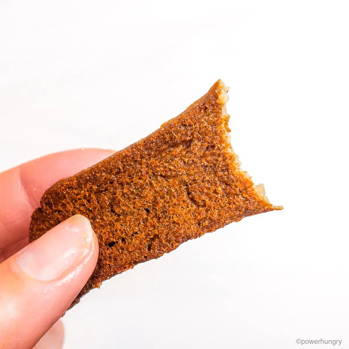 a strip of lentil tofu gyros held by a hand