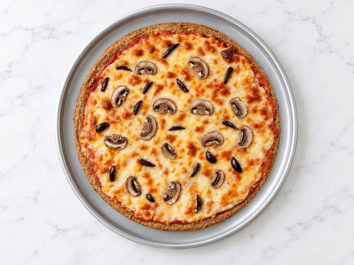 baked toppings on toppings added to the baked 2-ingredient pizza crust