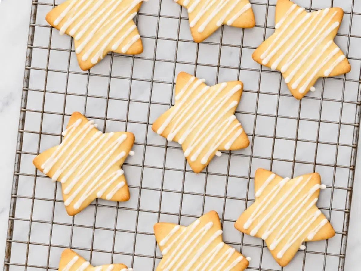 coconut icing drizzled on maple almond flour cut out cookies