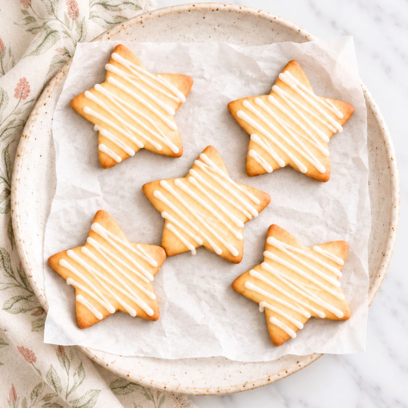 iced maple almond flour cut out cookies on plate