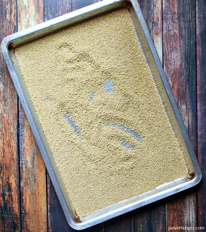 toasted millet on a silver baking sheet
