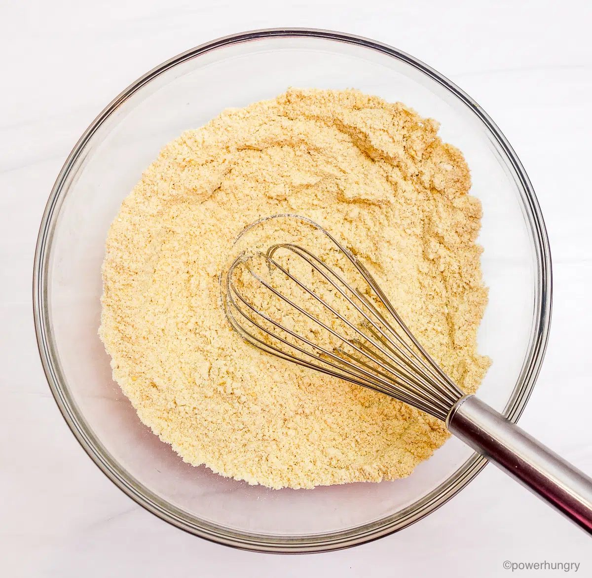 glass bowl with dry ingredients for millet biscuits