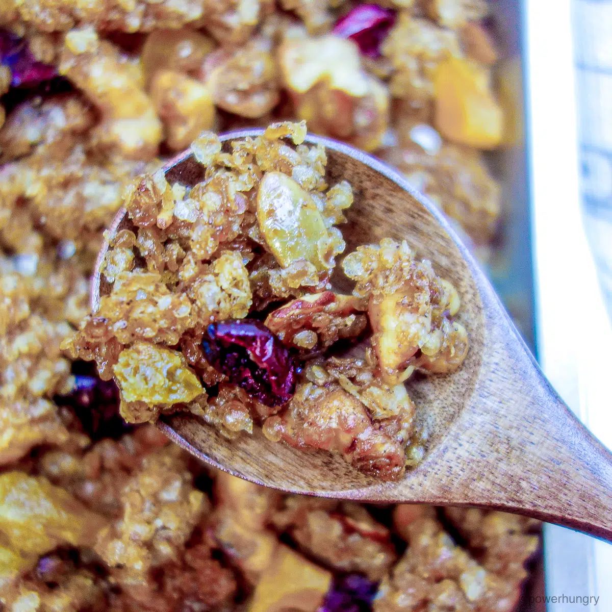 wooden spoon filled with millet granola