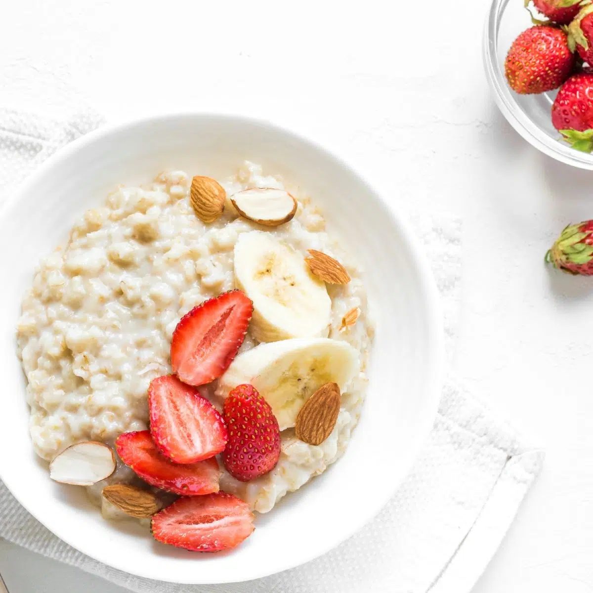 millet porridge and a bowl of strawberries
