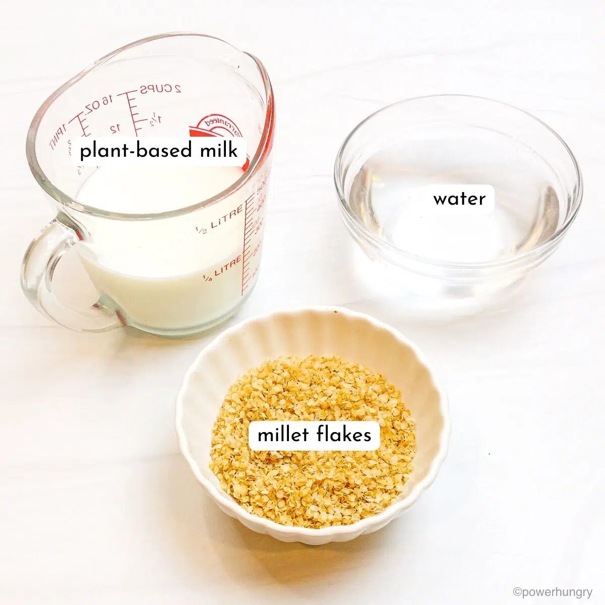 ingredients for millet porridge on a white marble surface