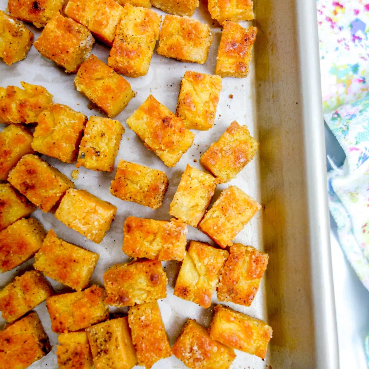 baked crispy lentil tofu on a baking sheet