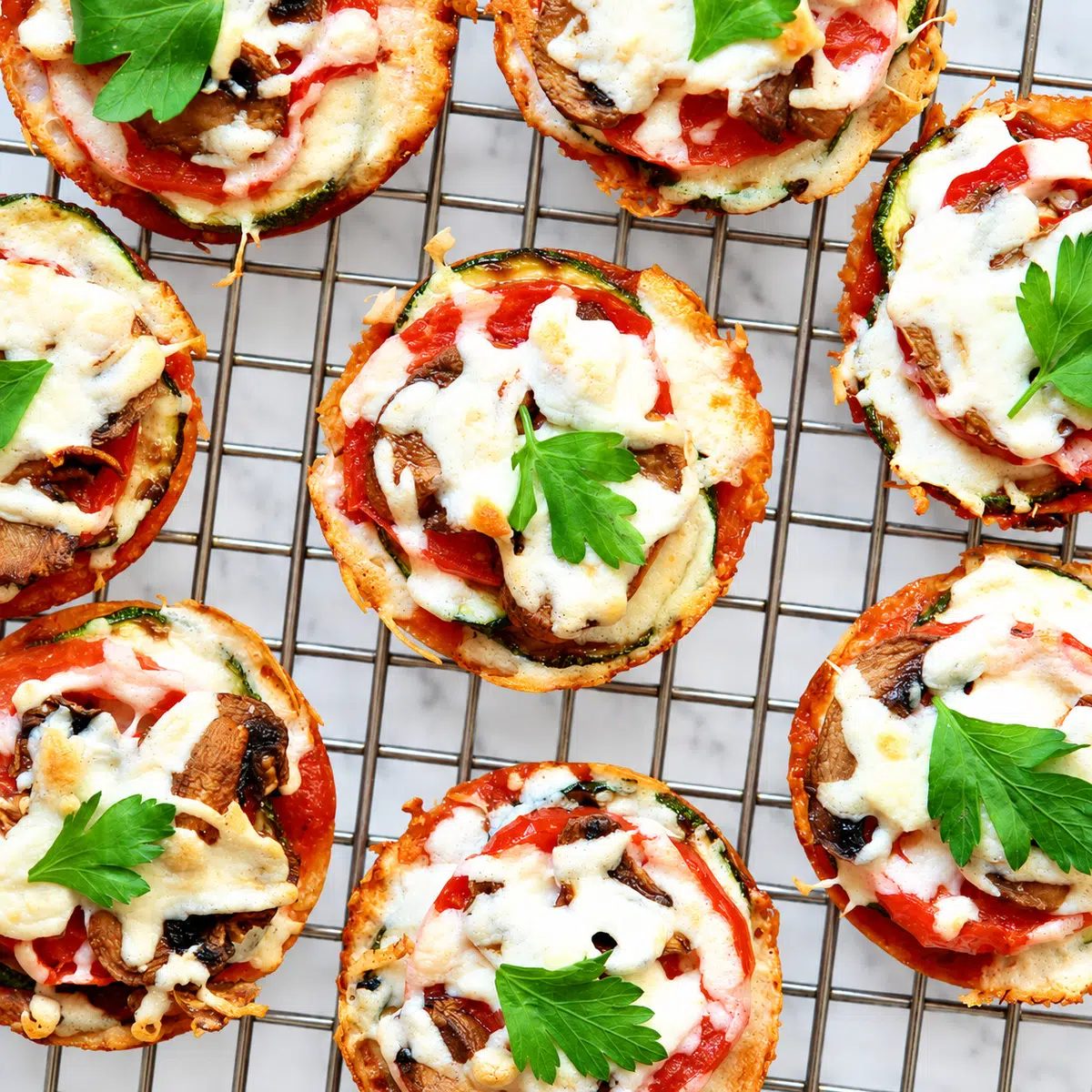 mini chickpea pizza crust pizzas on a rolling rack