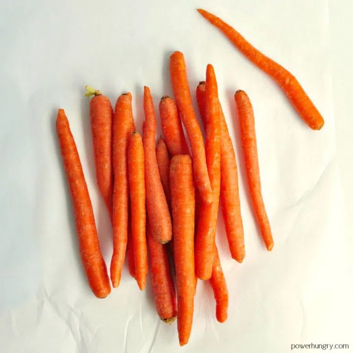 overhead shot of carrots on a piece of white parchment paper