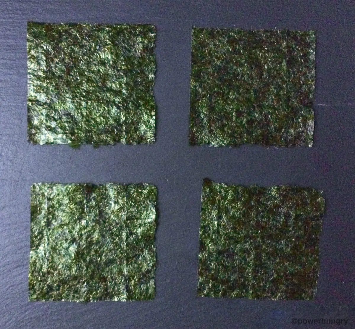 4 squares of nori on a piece of slate